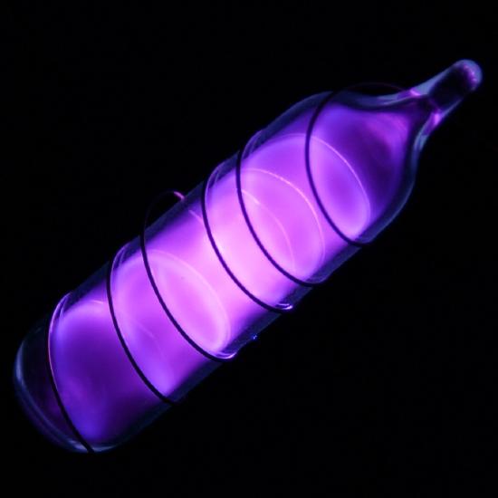 Vial containing glowing purple vapor. 