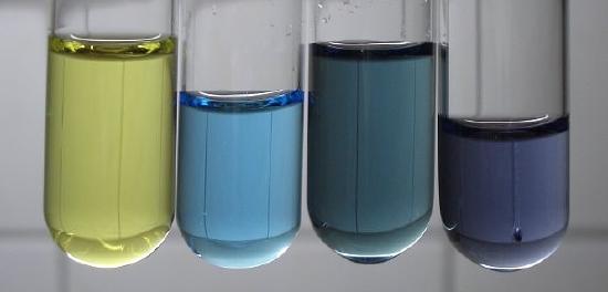 From left to right the color of the solution is clear yellow, to bright blue, dark green, and dark blue. 