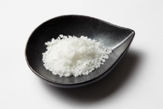 Bunch of salt in a small bowl. 