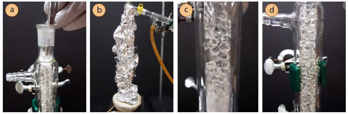  A: Glass wool plug on a fractionating column being removed. B: Fractionating column wrapped in aluminum foil. C: Closeup of fractionating column with glass beads inside. Condensation fog is visible at the bottom. D: Same closeup of fractionating column with liquid drips down the sides.
