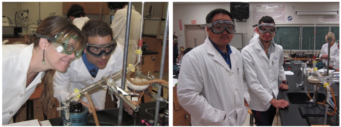 Students in lab coats working with distillation apparatuses.