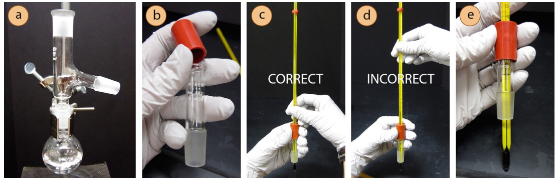  A: close-up of distillation flask. No condenser is attached. B: a red rubber fitting is attached to the thermometer adapter. C: A thermometer is inserted correctly into the adapter and does not extend past the adapter. D: A thermometer is inserted incorrectly into the adapter with the end extending through the adapter to hang out the end.