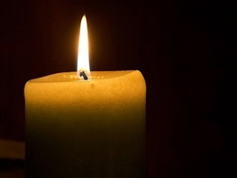 A candle flame glowing in darkness.
