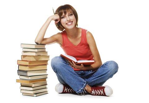 smiling_student_stack_of_books.jpg
