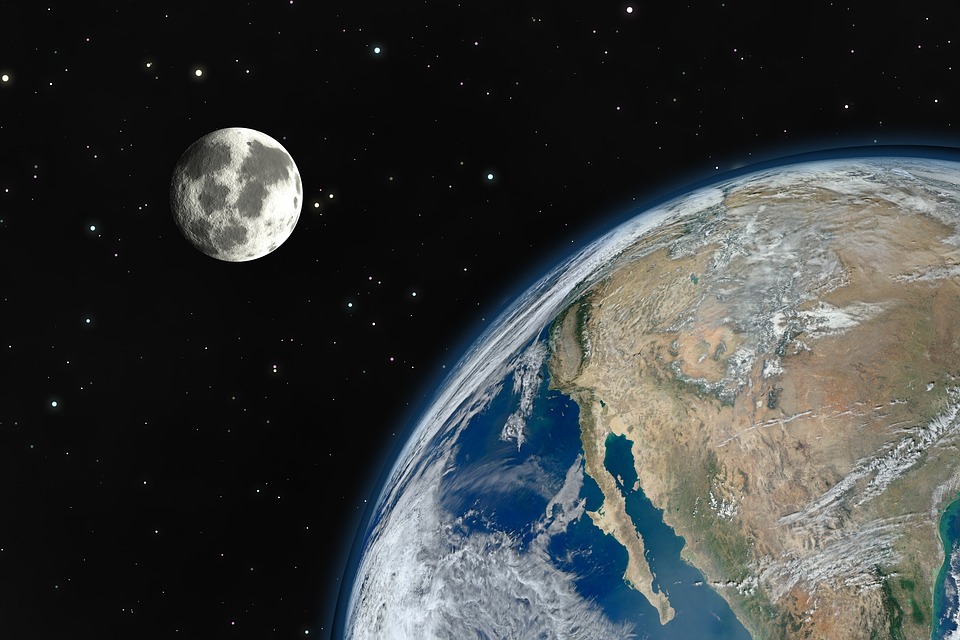 Image of the Moon, Earth’s Satellite, behind Earth in the distance.