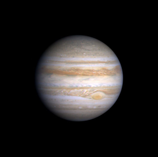 Image Jupiter – with cloud features like the Great Red Spot, Olivarez Blue Features, Belts and Bands. The black dot is the shadow of a moon.