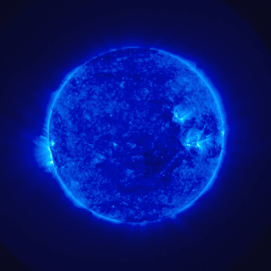 A spacecraft image of the Sun, taken in ultraviolet light, which shows various forms of solar activity.