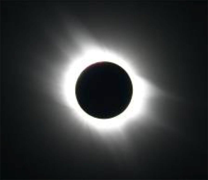 Black and white image showing the sun’s bright outer atmosphere.