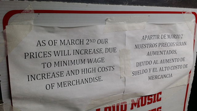 Sign on a store that reads, "As of March 2nd our prices will increase, due to minimum wage increase and high costs of merchandise."