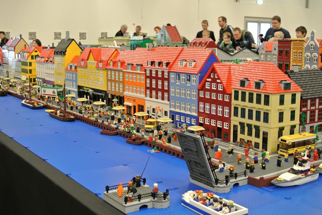A photo of visitors at Legoland in Billund, Denmark. The Lego city scene in the photo is a Norwegian fishing village.