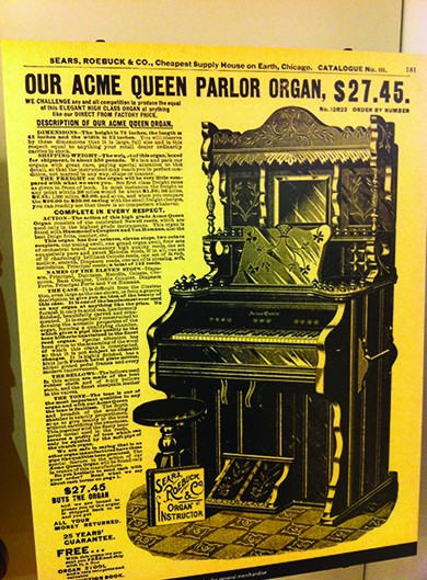 A page from the Sears, Roebuck & Co. catalog advertises, “Our Acme Queen Parlor Organ, $27.45,” followed by a drawing and description of the product. The header of the page reads “Sears, Roebuck & Co., Cheapest Supply House on Earth, Chicago.”