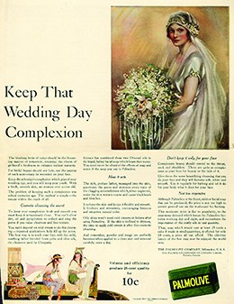 An advertisement headlined “Keep That Wedding Day Complexion” features an illustration of a rosy-cheeked, elaborately dressed bride. An image of Palmolive soap is shown alongside a lengthy description of the soap’s benefits. At the bottom, to illustrate that the soap contains oils used by Cleopatra, an image depicts two rosy-cheeked, white women dressed in flowing garments and seated in a room whose décor is reminiscent of ancient Egypt.
