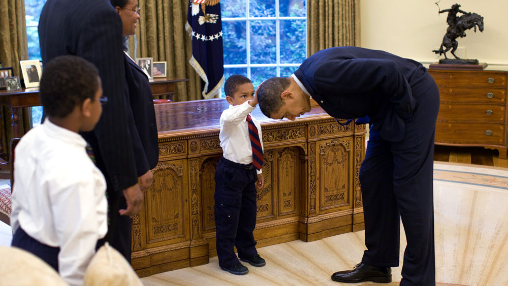 5-year old boy touches Obama's hair in the Oval Office.