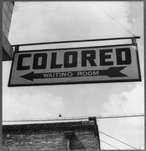 Sign stating "Colored Waiting Room" showing evidence of discrimination based upon race.