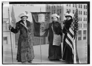 Mrs. J. Hardy Stubbs, Miss Ida Craft, Miss Rosalie Jones; Photo shows 3 suffragettes with bag "Votes for Women pilgrim leaflets."