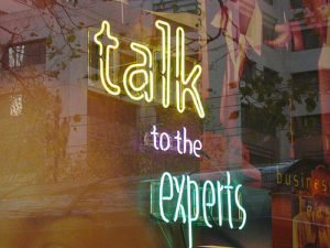 neon sign reading "talk to the experts"