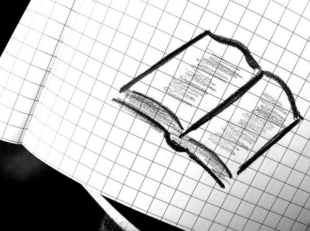 corner of graphing paper showing a doodle of an open book