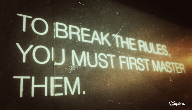 Slogan printed on a wall: To break the rules, you must first master them.