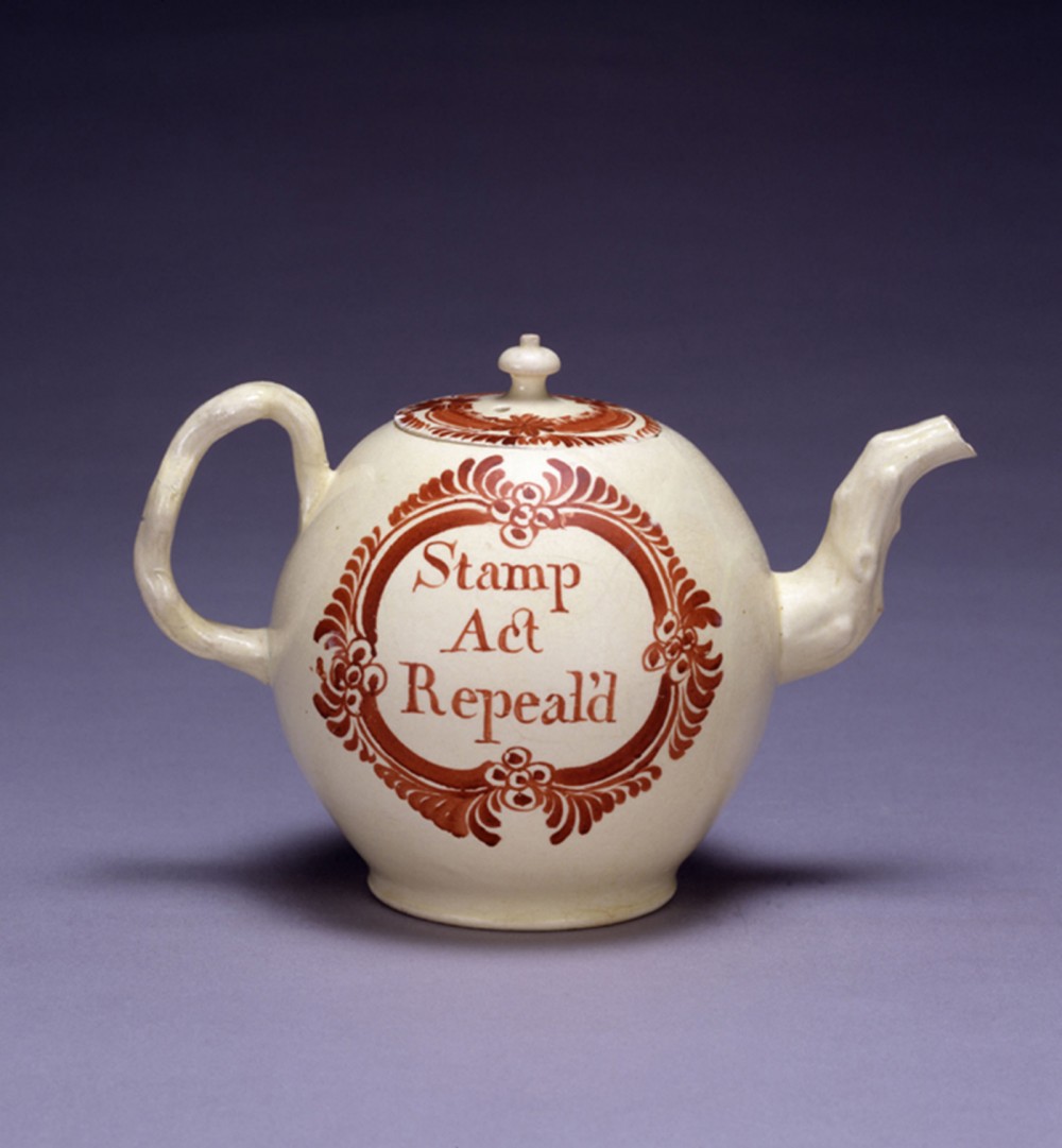 A teapot that bears the words "Stamp Act Repealed."