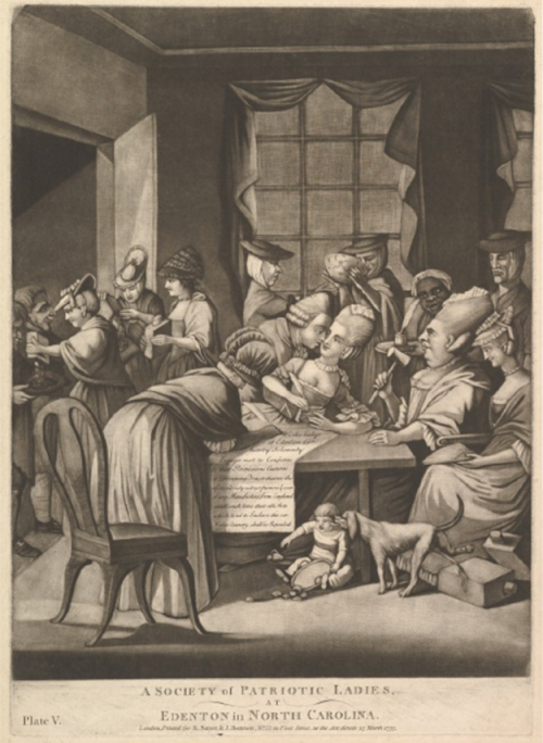 Women gathered around and writing a document.
