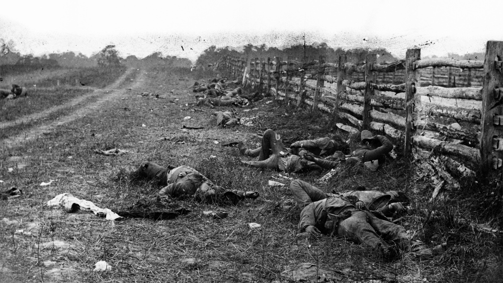 Photograph of dead soldiers in a field.