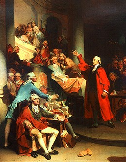 A painting shows Patrick Henry making a speech to a room full of well-dressed colonists. As Henry gestures dramatically with his arm, the members of his audience look on and whisper to one another.
