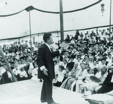 A photograph shows Robert La Follette speaking animatedly to a large crowd.