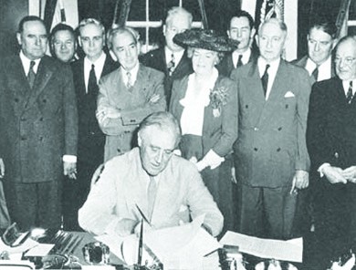 A photograph shows Franklin D. Roosevelt seated at a desk signing the GI Bill, surrounded by members of Congress.