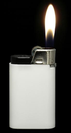 A white lighter showing a flame against a black background.
