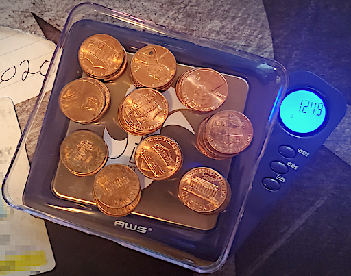 A collection of pennies having a mass of 124.9 g. 
