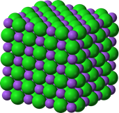 Sodium chloride crystal lattice that shows a cube composed of large and small spheres representing chlorine and nitrogen, respectively. 