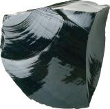 A large, irregular chunk of shiny black obsidian with smooth, curved surfaces and sharp edges.