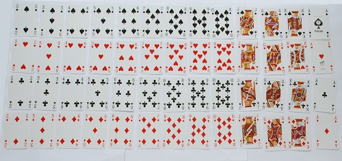 An image of a deck of playing cards laid out separated by suit and in order from 2 to ace.