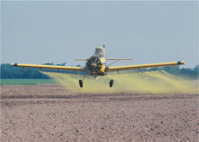 A photograph shows agricultural pest control operations as a plane releases pesticides over a cultivated farmland