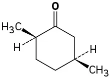 Cyclohexane ring in which one carbon has methyl (wedge) and H (dash) substituents, adjacent (clockwise) carbon has oxo, and two carbons further clockwise has methyl (wedge) and H (dash) groups.