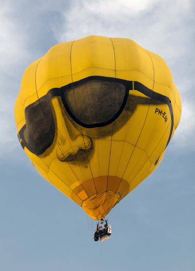photograph of a hot air balloon floating in the sky.