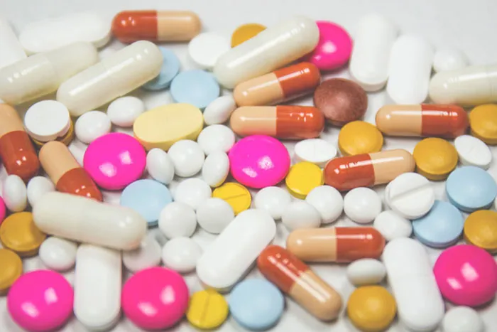 An image displays different colorful barbiturates as tablets, pills, and capsules.