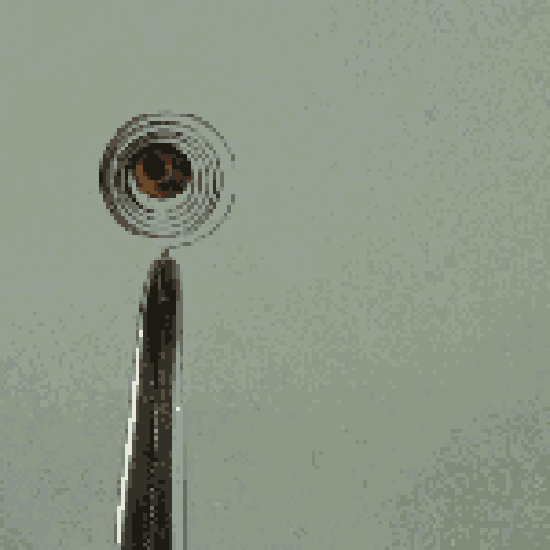 A GIF of a small bimetal coil being held by a pair of forceps. When a lighter is placed near the coil, it expands. When the lighter is removed, the coil contracts.