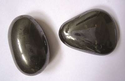 Two rounded, smooth black stones are shown.