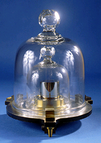 a metal cylinder placed in a tightly secured glass bell jar. 