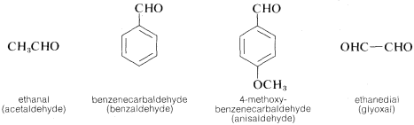 From left to right: C H 3 C H O. Labeled ethanal (acetaldehyde). Benzene ring with C H O substituent. Labeled benzenecarbaldehyde (benzaldehyde). Benzene ring with C H O substituent on carbon 1 and O C H 3 substituent on carbon 4. Labeled 4-methoxy-benzenecarbaldehyde (anisaldehyde). O H C single bond C H O. Labeled ethanedial (gyloxal).