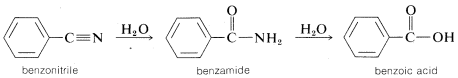 Benzene ring with a C triple bond N substituent labeled benzonitrile. Arrow with H 2 O goes to benzene with C with a double bond O and single bond N H 2 substituent. Labeled benzamide. Arrow with H 2 O goes to benzene with a C with a double bond O and a single bond O H labeled benzoic acid.