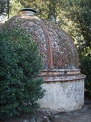 Round stone building with a curved roof.