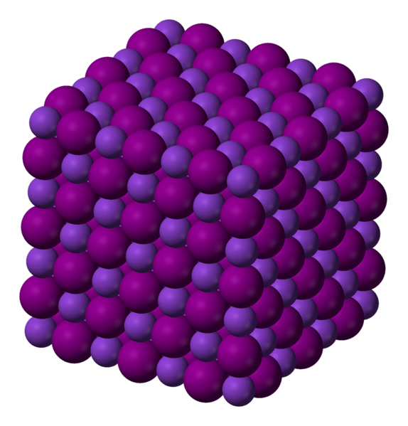 Dos esferas con diferentes tonalidades de púrpura están apretadas en una estructura rígida para formar un cubo.