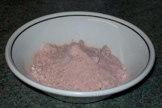 Finely ground light pink salt in a bowl.