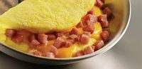 Image of a cheese omelette with cubed spam. 