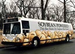 Picture of a bus with a large print of the words "soybean powered" on its exterior. 