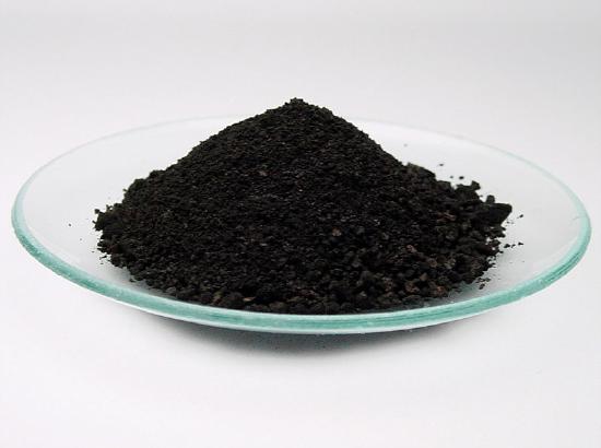 Black powder on a glass petri dish. 