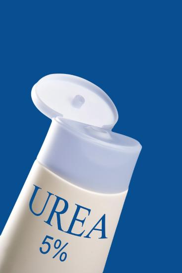 A white and light blue bottle of 5% urea is shown against a dark blue background.