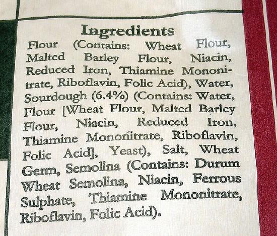The ingredients list contains Flour (Contains: wheat flour, malted barley flour, niacin, reduced iron, thiamine mononitrate, riboflavin, folic acid), water, sourdough (6.4%) (contains: water, flour [wheat flour, malted barley flour, niacin, reduced iron, thiamine mononitrate, riboflavin, folic acid], yeast), salt, wheat germ, semolina (contains: durum wheat semolina, niacin, ferrous sulphate, thiamine mononitrate, riboflavin, folic acid).